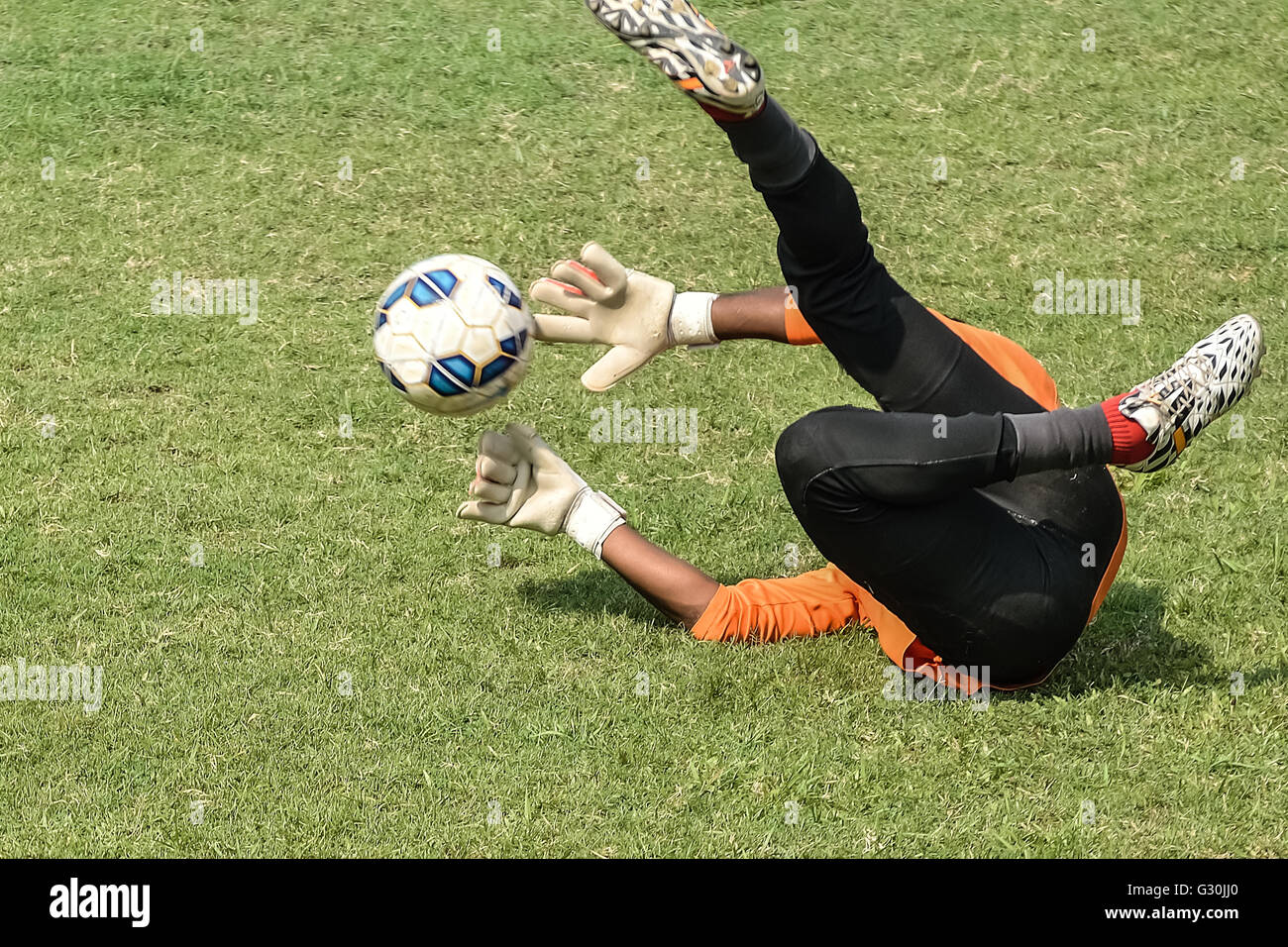 In play soccer goalkeeper is to catching a ball. Stock Photo
