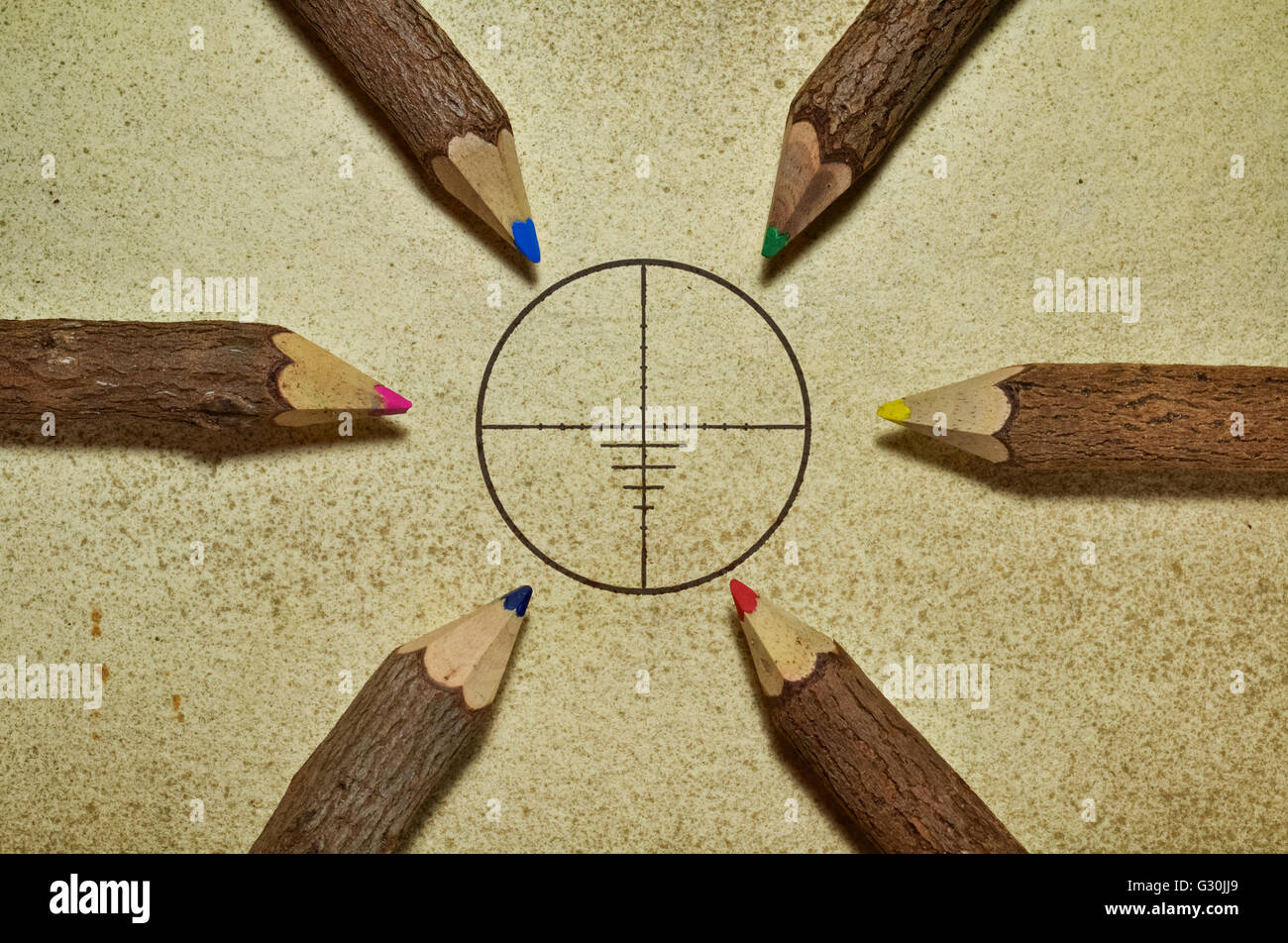 Target surrounded with pencils on grunge background Stock Photo
