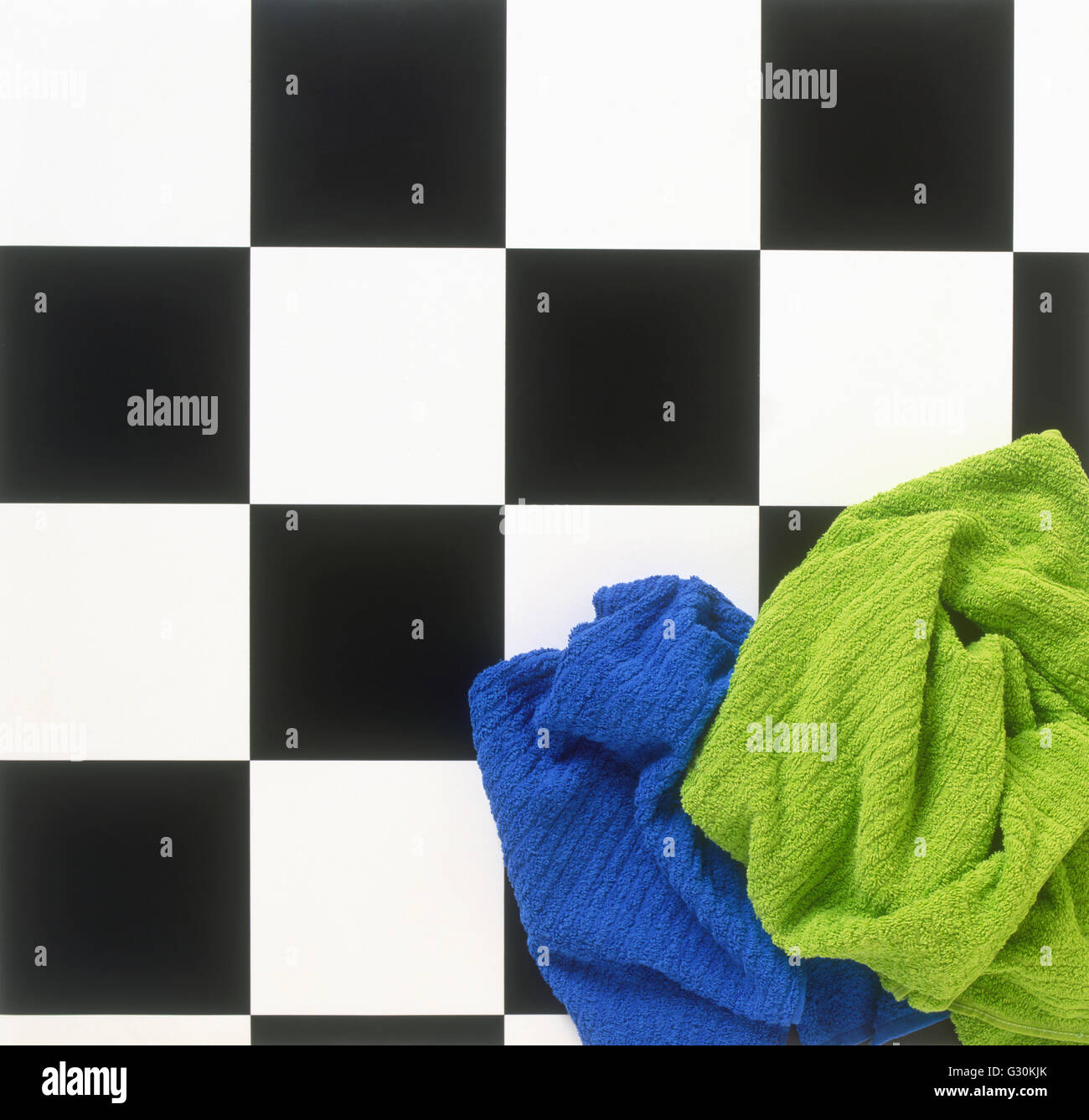 Towels on black and white bathroom floor, view from above Stock Photo