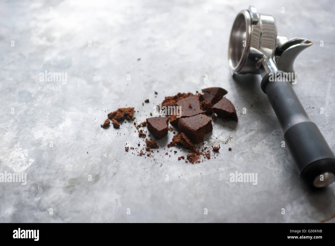 Espresso machine basket (portafilter) and used coffee grinds Stock