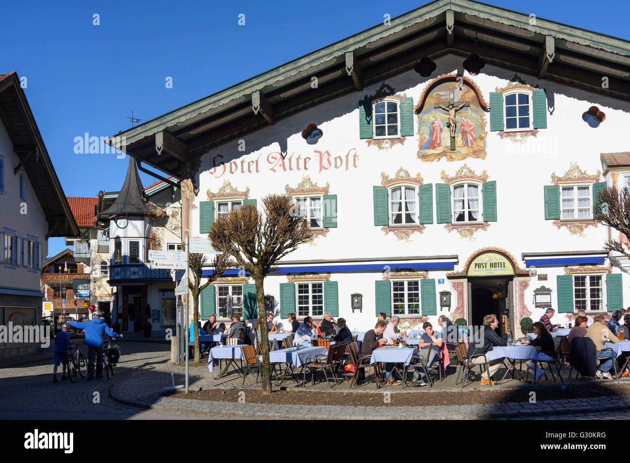 Hotel ' Alte Post ' with Lüftlmalerei and cyclists, Germany, Bayern, Bavaria, Oberbayern, Upper Bavaria, Oberammergau Stock Photo