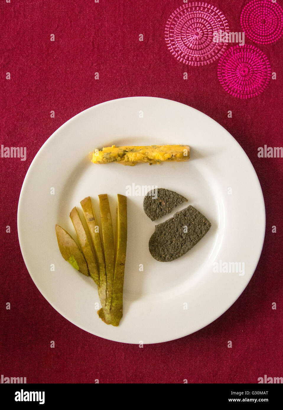 Sliced pear, cheese and a broken heart. Comfort food. Stock Photo