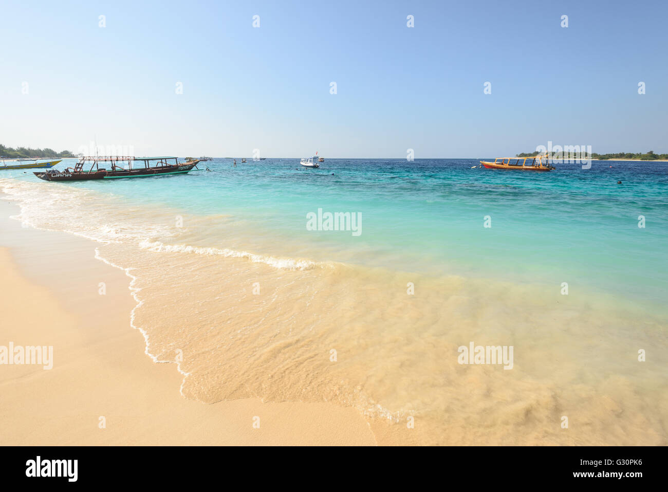 Boats anchored off Gili trawangan island in Indonesia Stock Photo