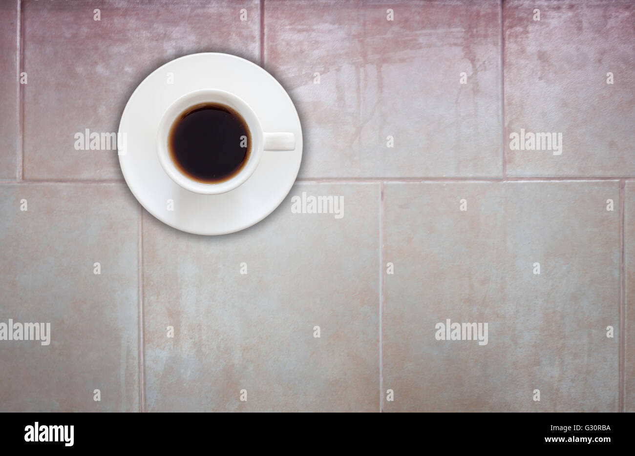 Top view of coffee cup on ceramic tiles wall texture background Stock Photo
