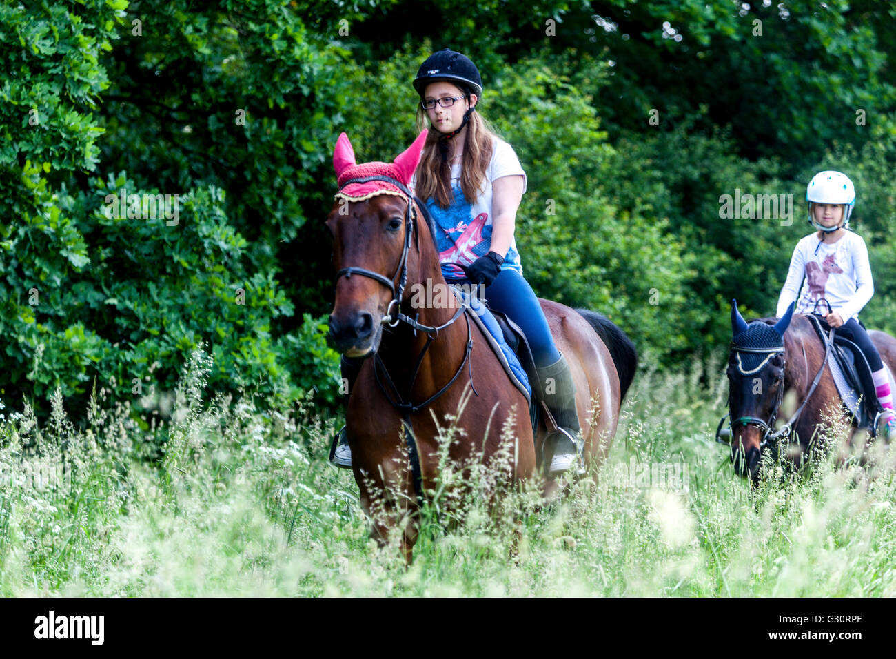 Horseback riding summer landscape Girls trekking Stock Photo