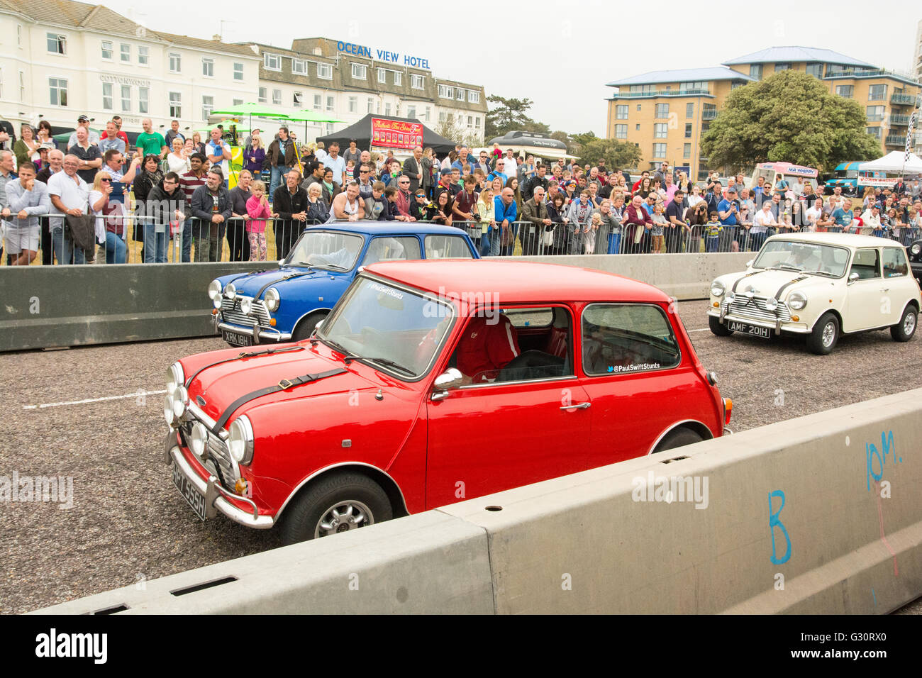 Three classic Mini cars re-enact scenes from the film The Italian Job at the Bournemouth Wheels Festival, June 2016. Stock Photo