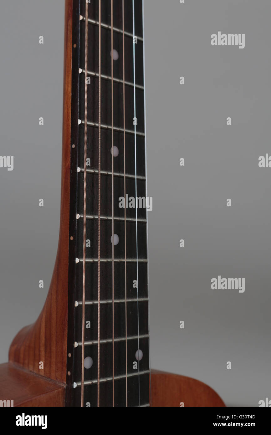 Detail of the neck of a red colored wood acoustic guitar Stock Photo