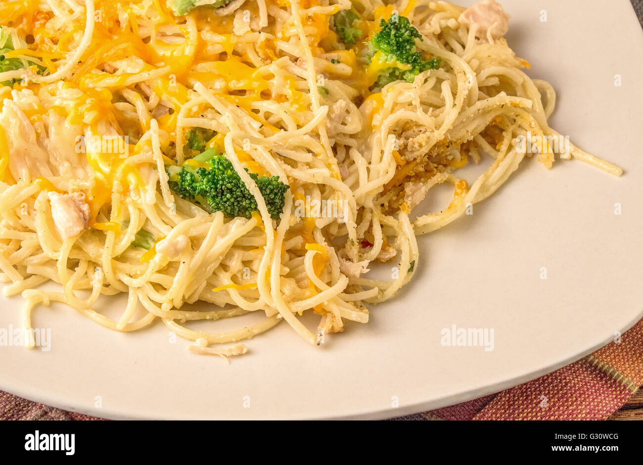 Chicken Alfredo. Plate of delicious and easy to prepare chicken alfredo topped with shredded cheese and broccoli. Stock Photo