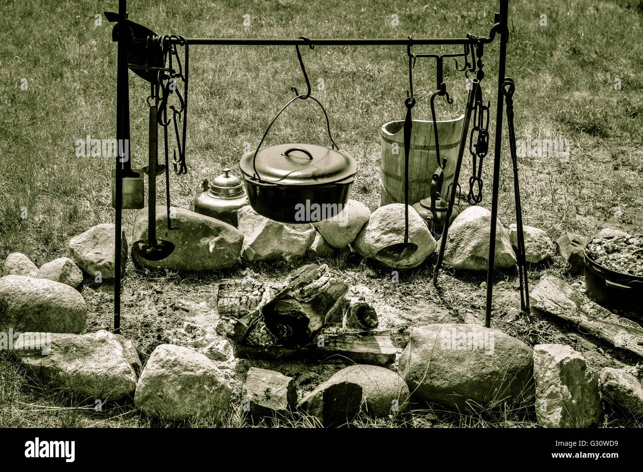 Cooking Over A Campfire. Black cauldron over an open campfire in black