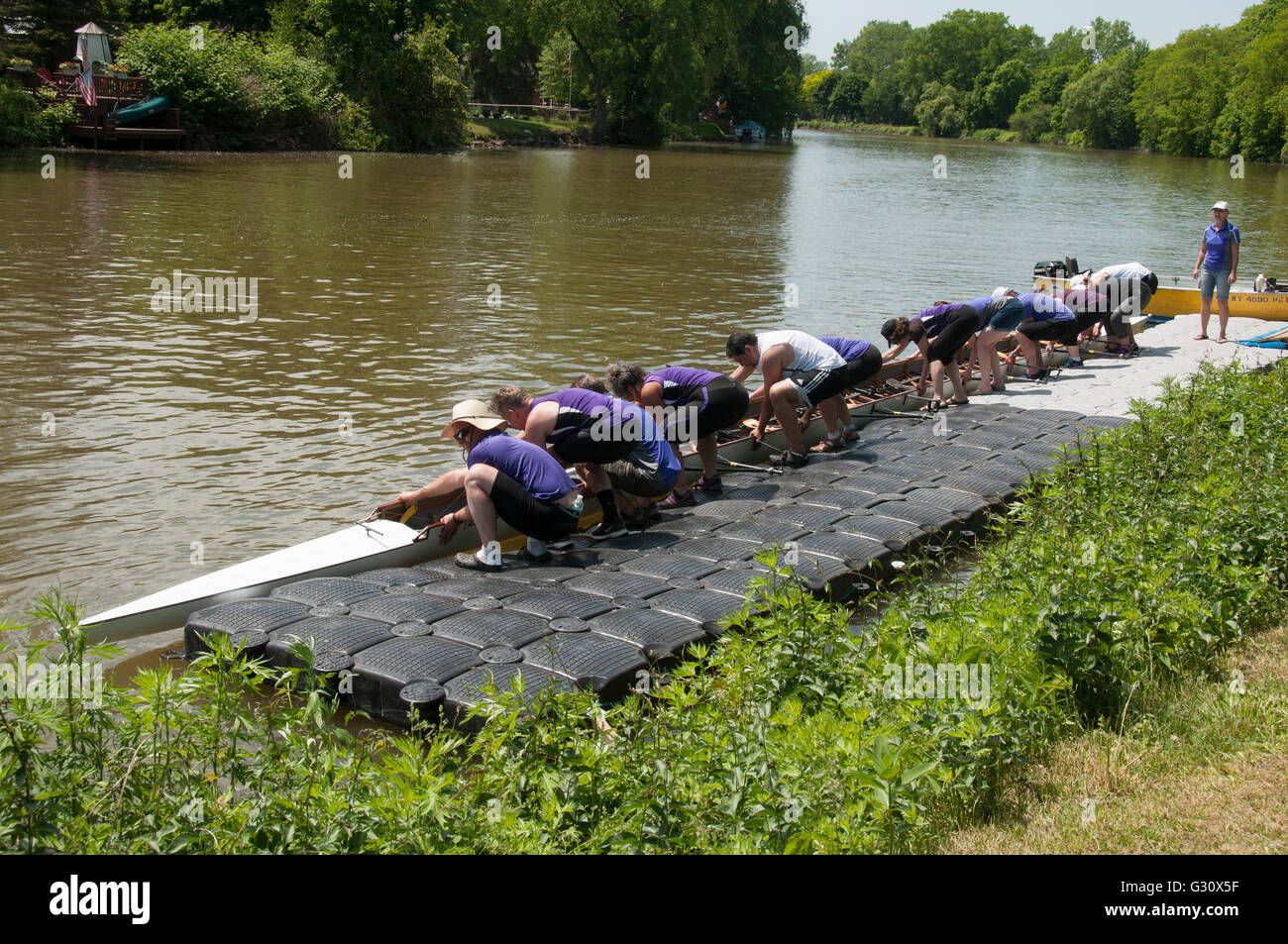 Rowing crew removing shell from water Stock Photo - Alamy