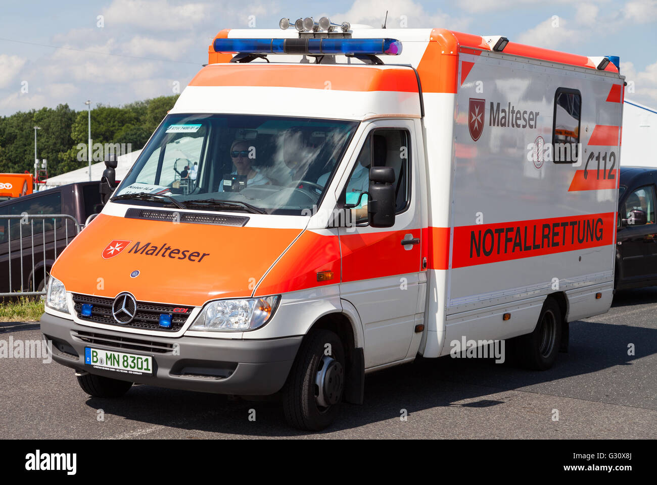 BERLIN / GERMANY - JUNE 3, 2016: german ambulance car from Malteser drives on a street in Berlin / Germany on may 3, 2016. Stock Photo
