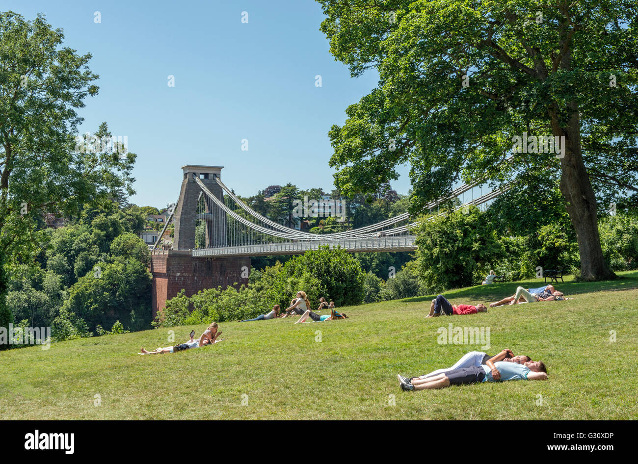 The Clifton Suspension bridge Clifton Down, Bristol, on a hot and sunny day with folk relaxing on the grass. Stock Photo