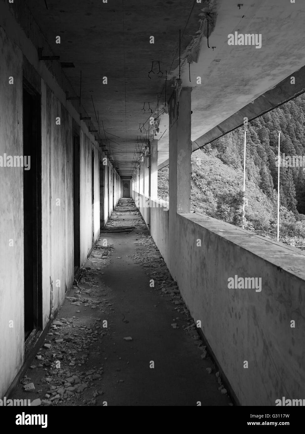 Black and white image of an abandoned building corridor Stock Photo