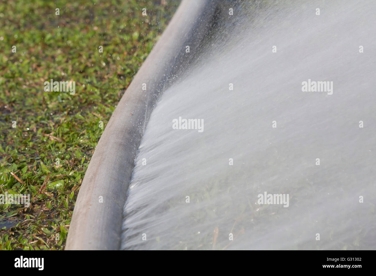 water leaking from hole in a hose Stock Photo