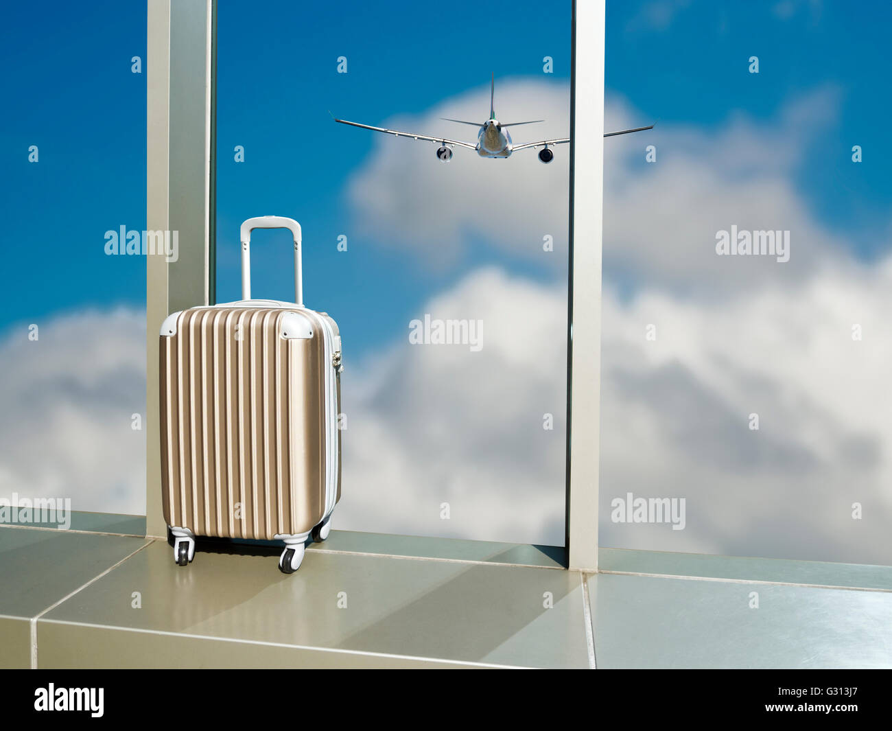 business travel,suitcase on window in airport against cloud sky with airplane Stock Photo