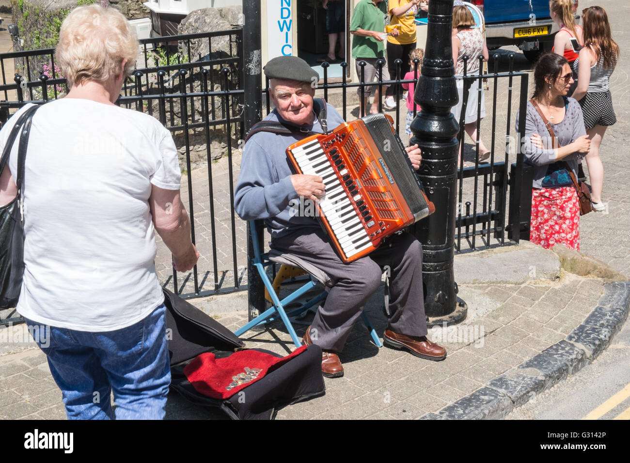 Accordion player busking,busker In coastal resort town of Tenby