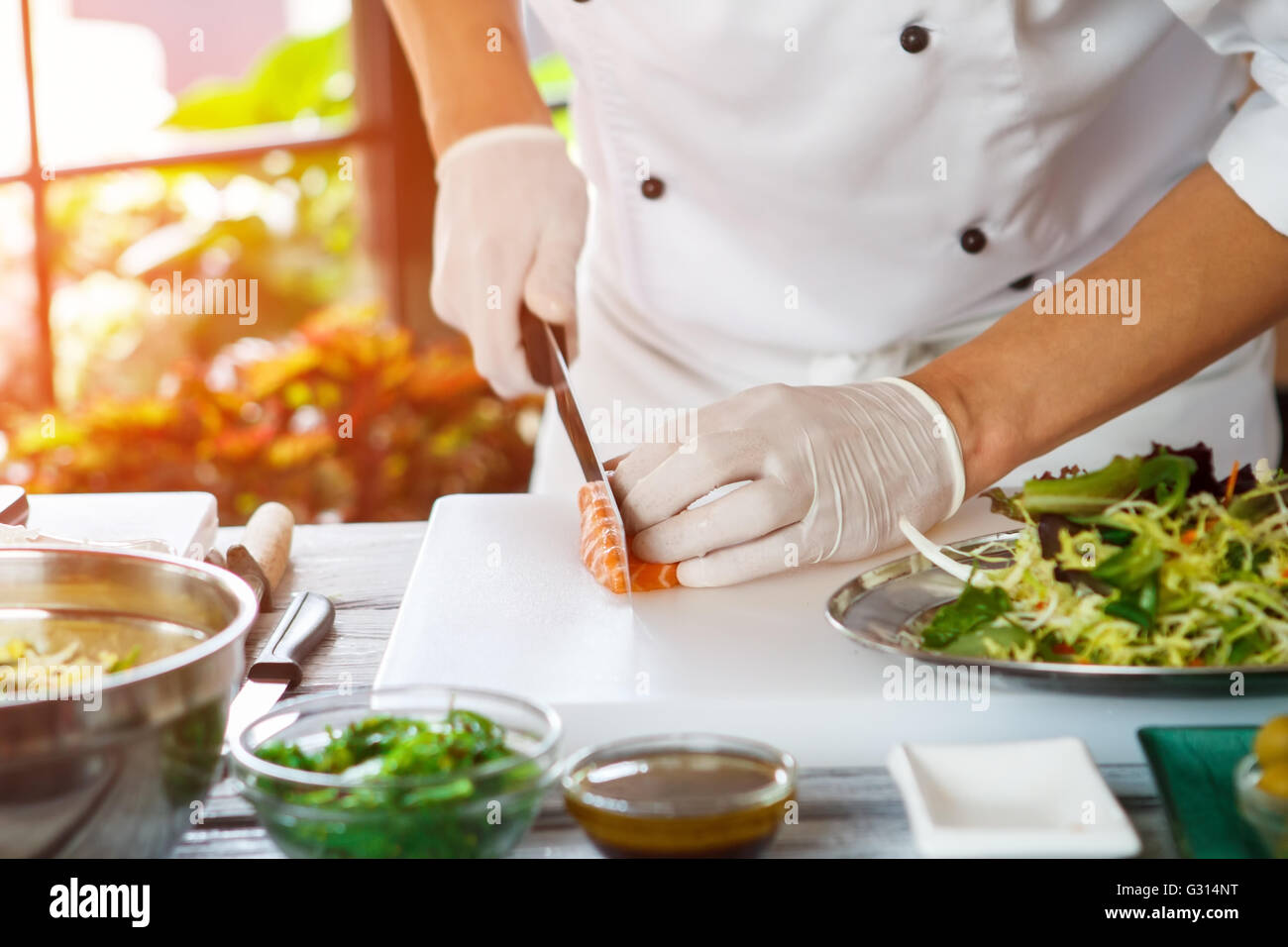 Hand with knife cuts fish Stock Photo Alamy