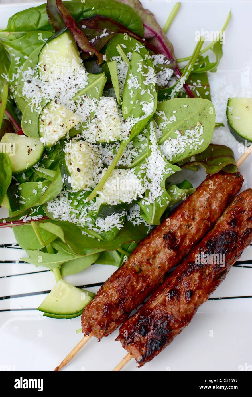 Kebab sticks served with a green salad Stock Photo