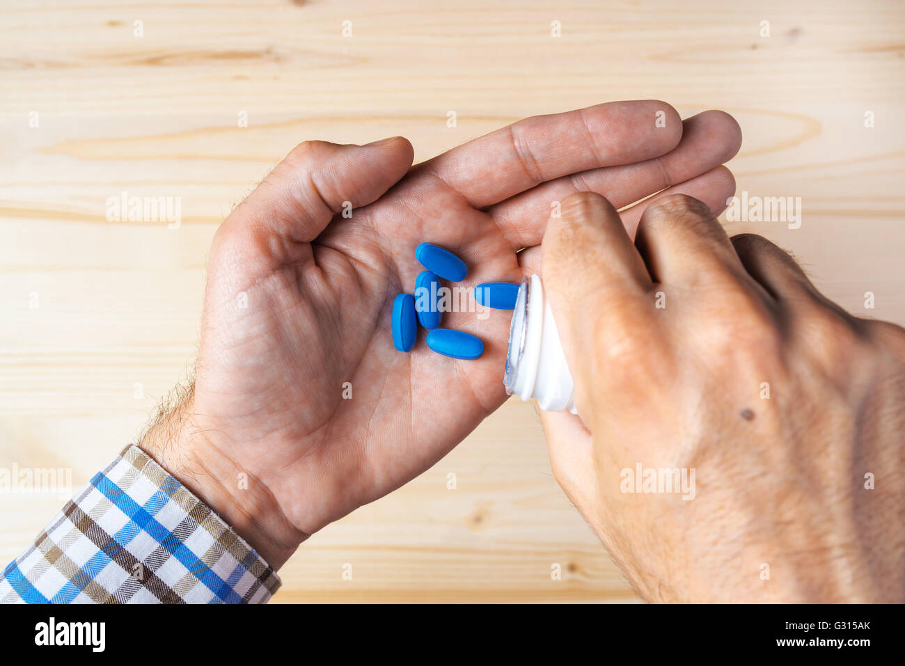 Top view pov of adult man taking blue pills, selective focus Stock Photo -  Alamy