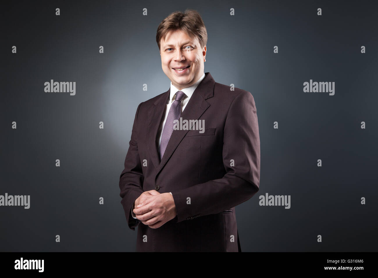 Successful businessman smiling at camera Stock Photo - Alamy