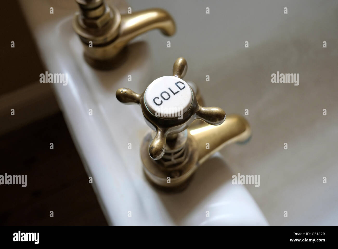 brass cold tap on old victorian style bath Stock Photo
