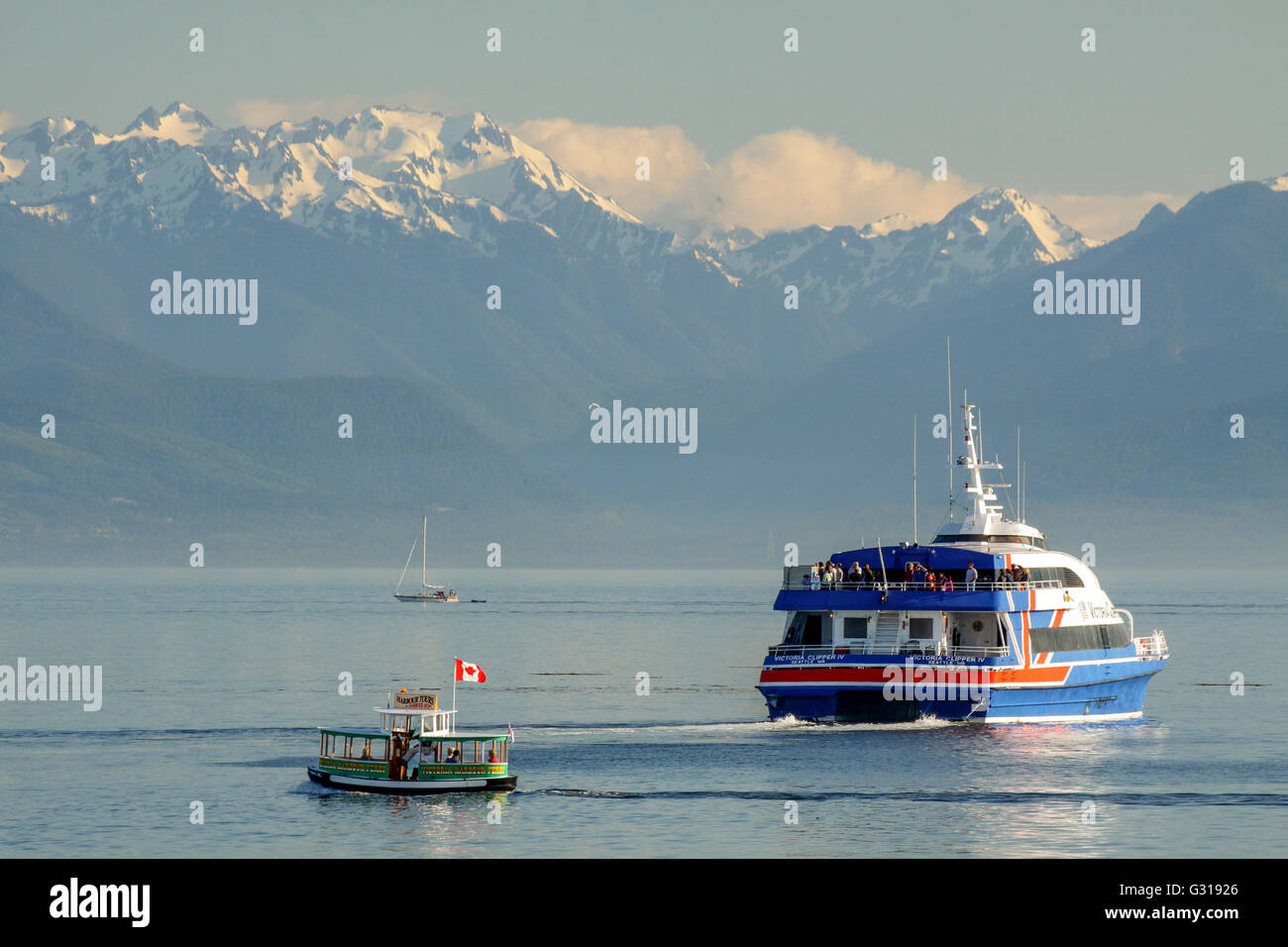 Victoria Clipper catamaran ferry and small harbor ferry-Victoria, British Columbia, Canada. Stock Photo