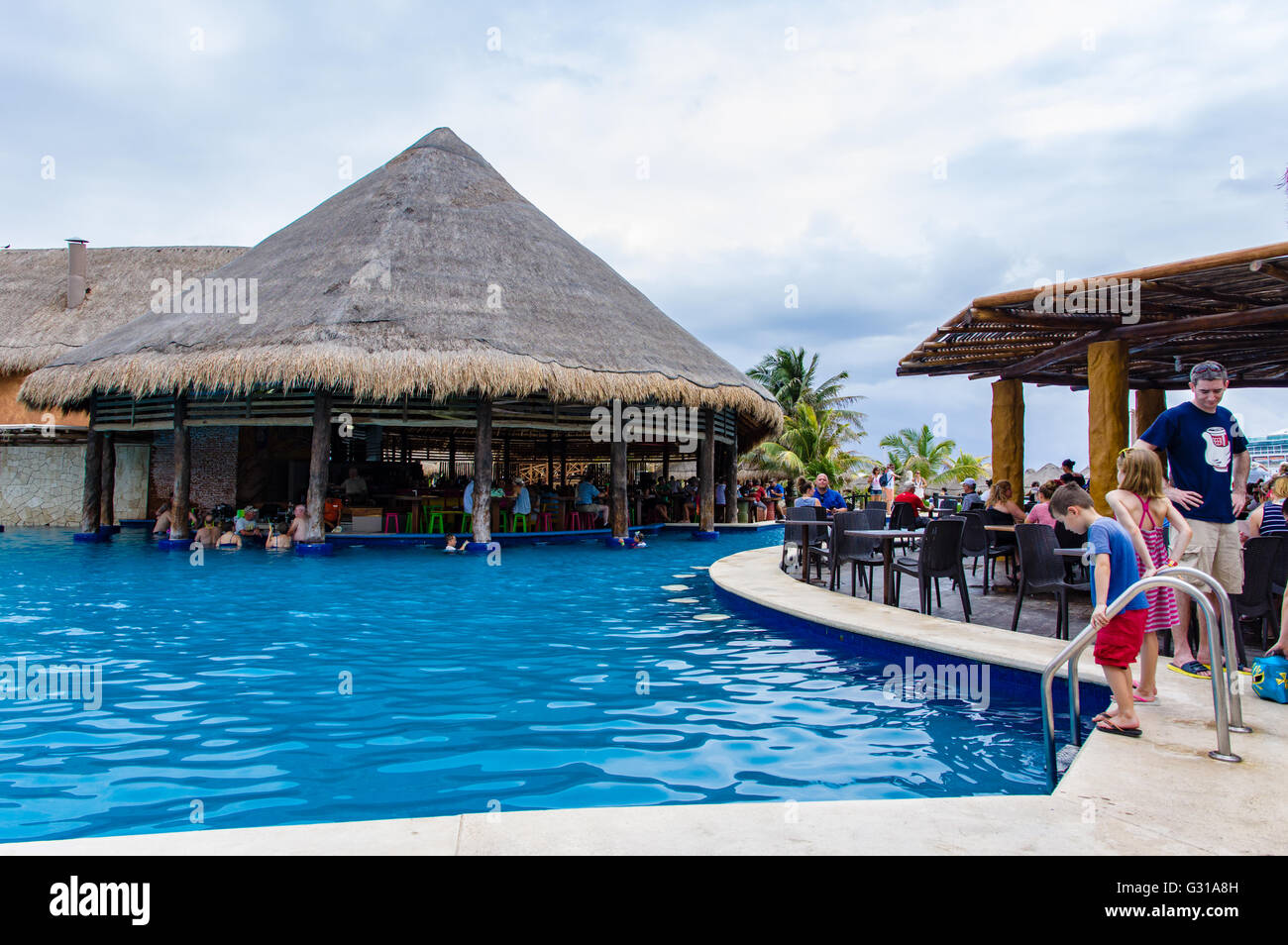 Tourists enjoy the weather at a swim up bar in Costa Maya, Mexico Stock
