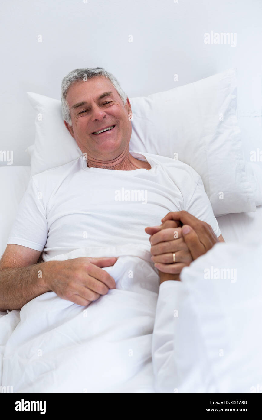 Male doctor consoling senior man Stock Photo