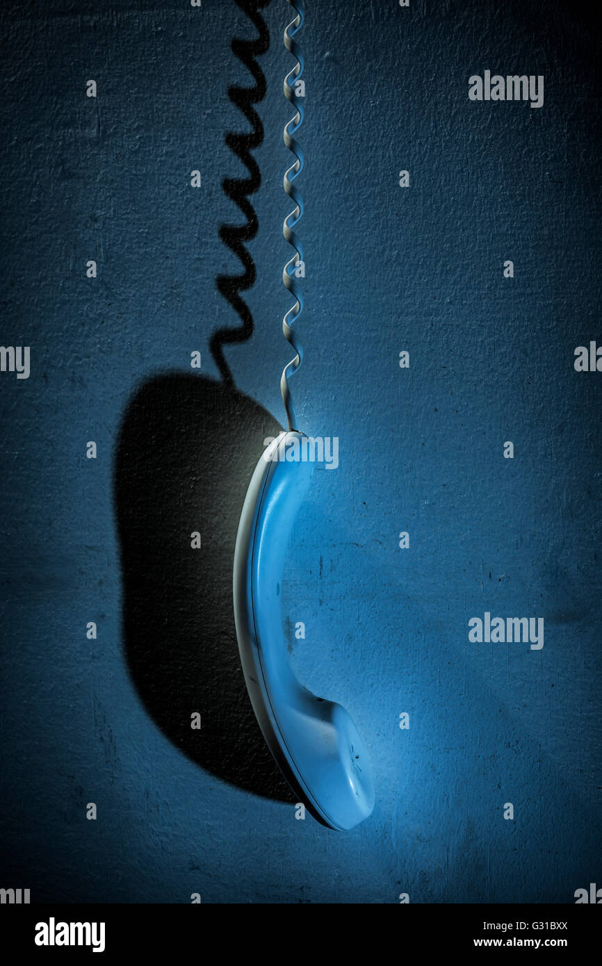 Telephone receiver left hanging. Stock Photo