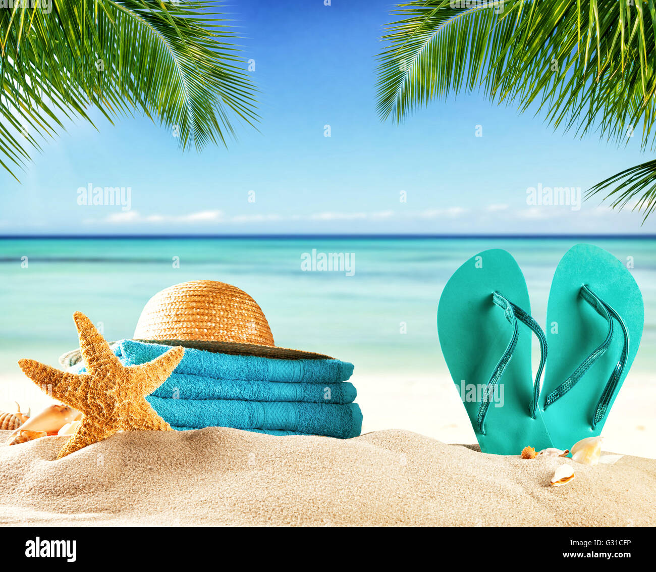 Summer accessories on sandy beach, blur sea on background. Summer exotic relaxation concept Stock Photo