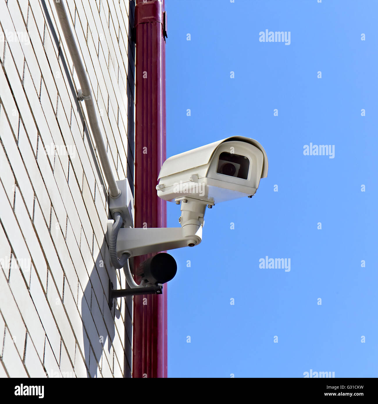 video surveillance camera on a wall of the building Stock Photo Alamy