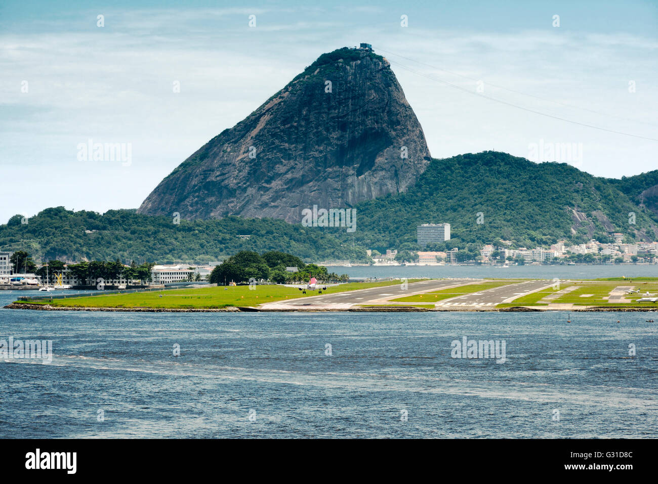 View Of A Passenger Airplane Landing At The Rio De Janeiro Airport With The City At The Background, Brazil Stock Photo