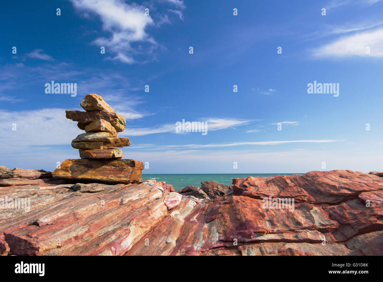 sea beach stone stack stable and wave splash abstract and blue sky background Stock Photo