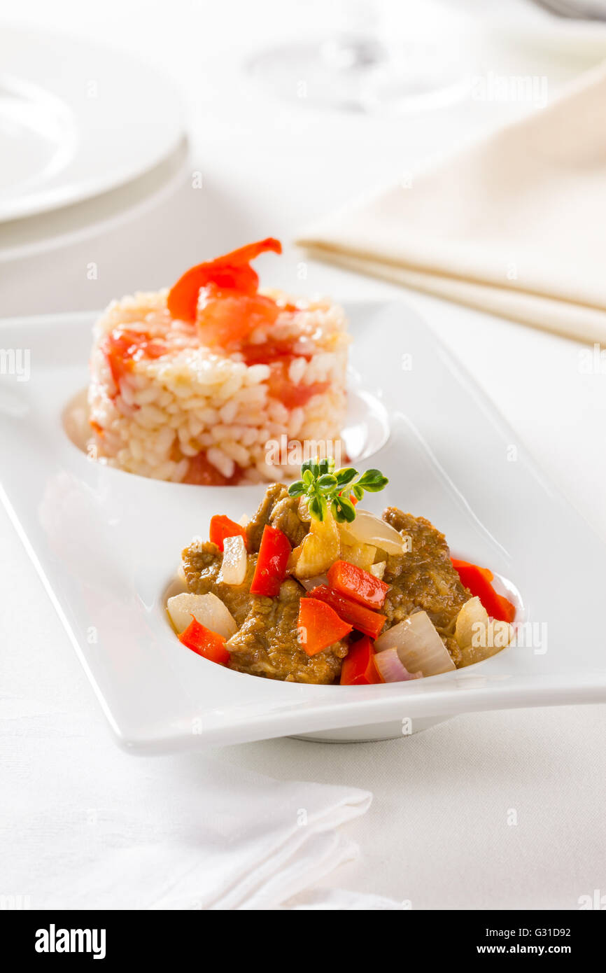 A beef stew with bell pepper and onions, served with rice Stock Photo