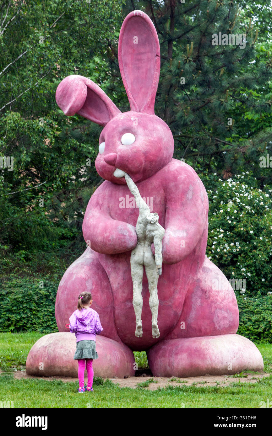 Czech modern sculpture outdoor Statue of pink rabbit that eats human by Adam Trbusek, Pilsen
