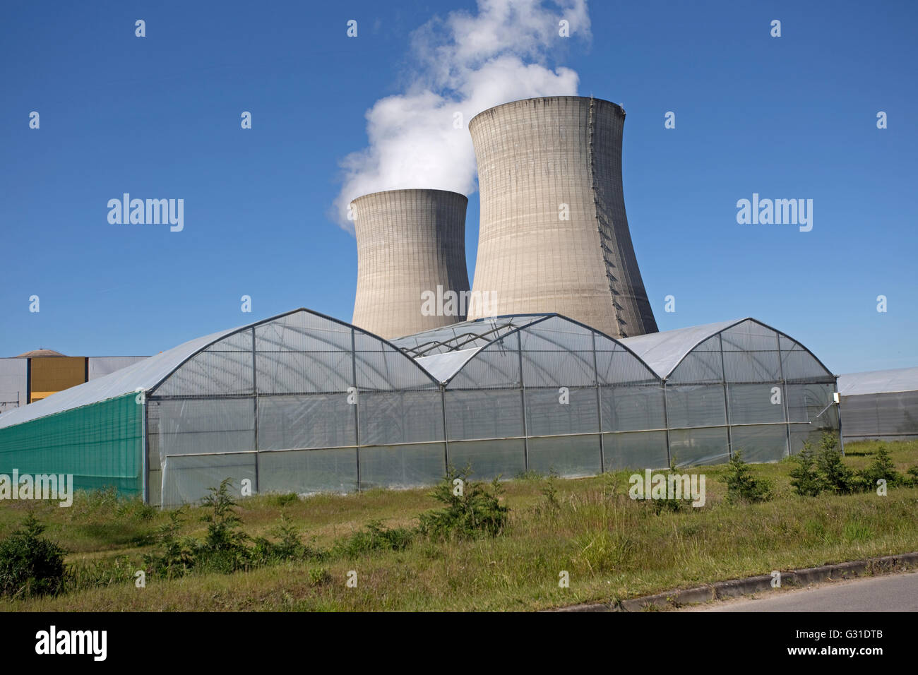 Greenhouse growing plants near cooling towers EDF nuclear power plant DampierreenBurly France