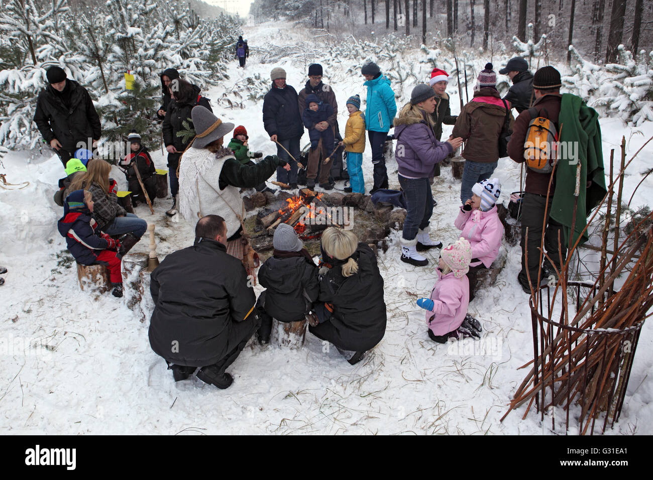 Neuenhagen, Germany, people sit in the winter on a campfire in forest Stock Photo