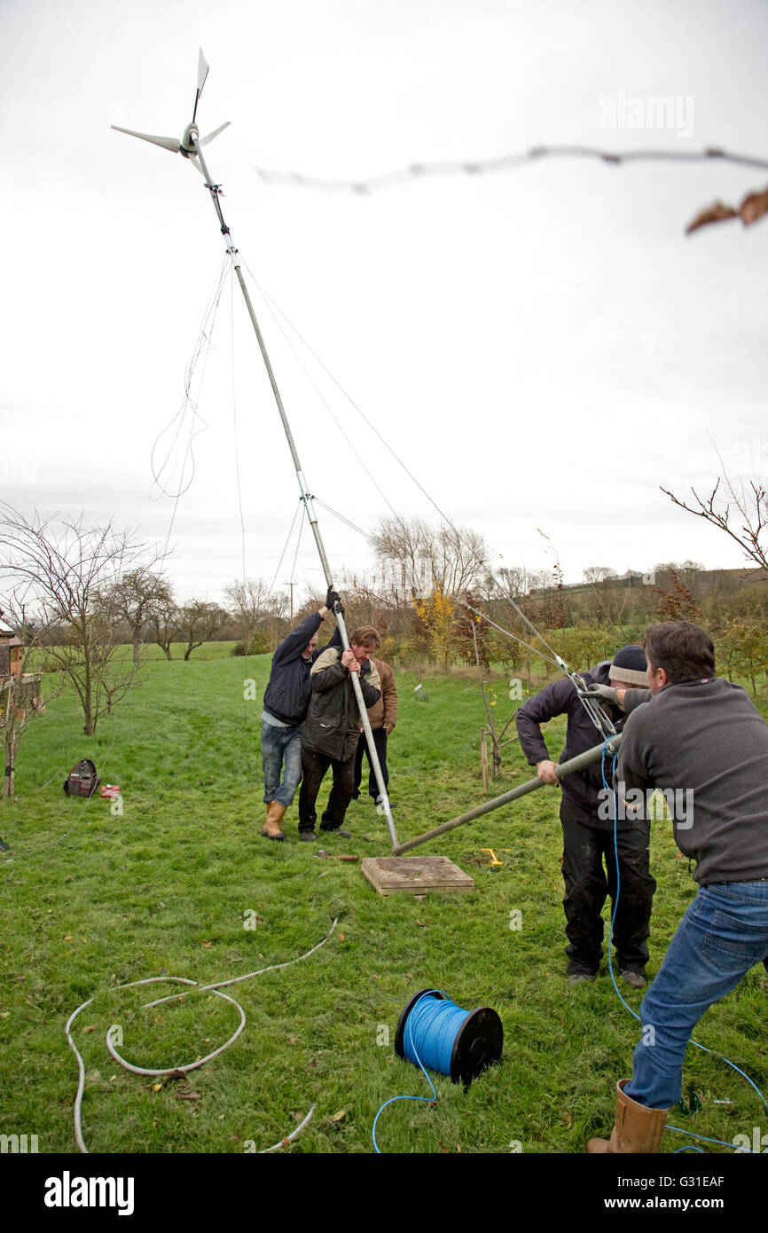 Engineers erecting FutureEnergy 1kW wind turbine Colemans Hill Farm UK