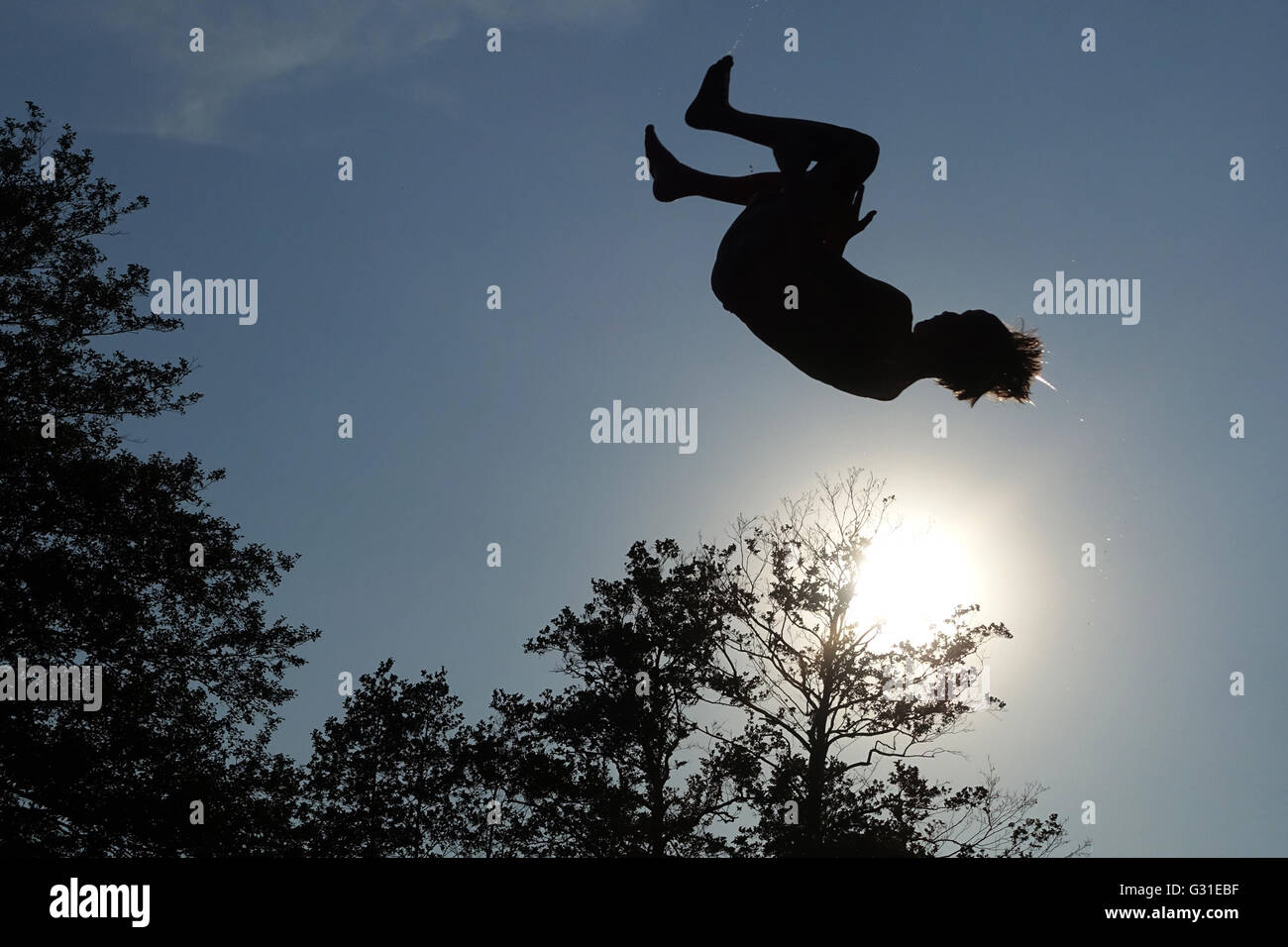 Briescht, Germany, Silhouette, Boy beats a somersault in the air Stock Photo
