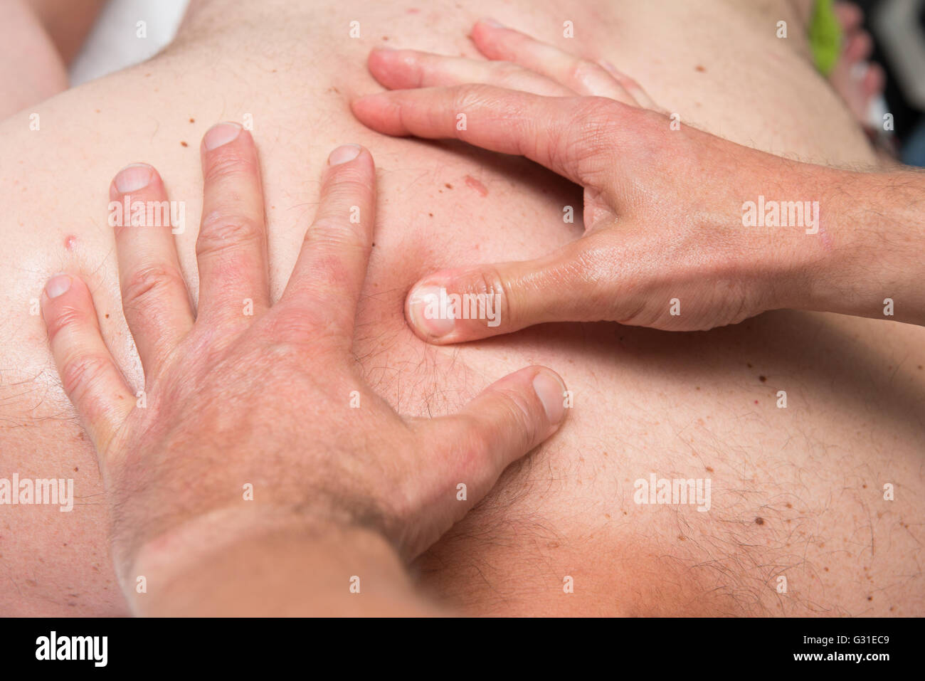 Massage therapist is working with a client Stock Photo