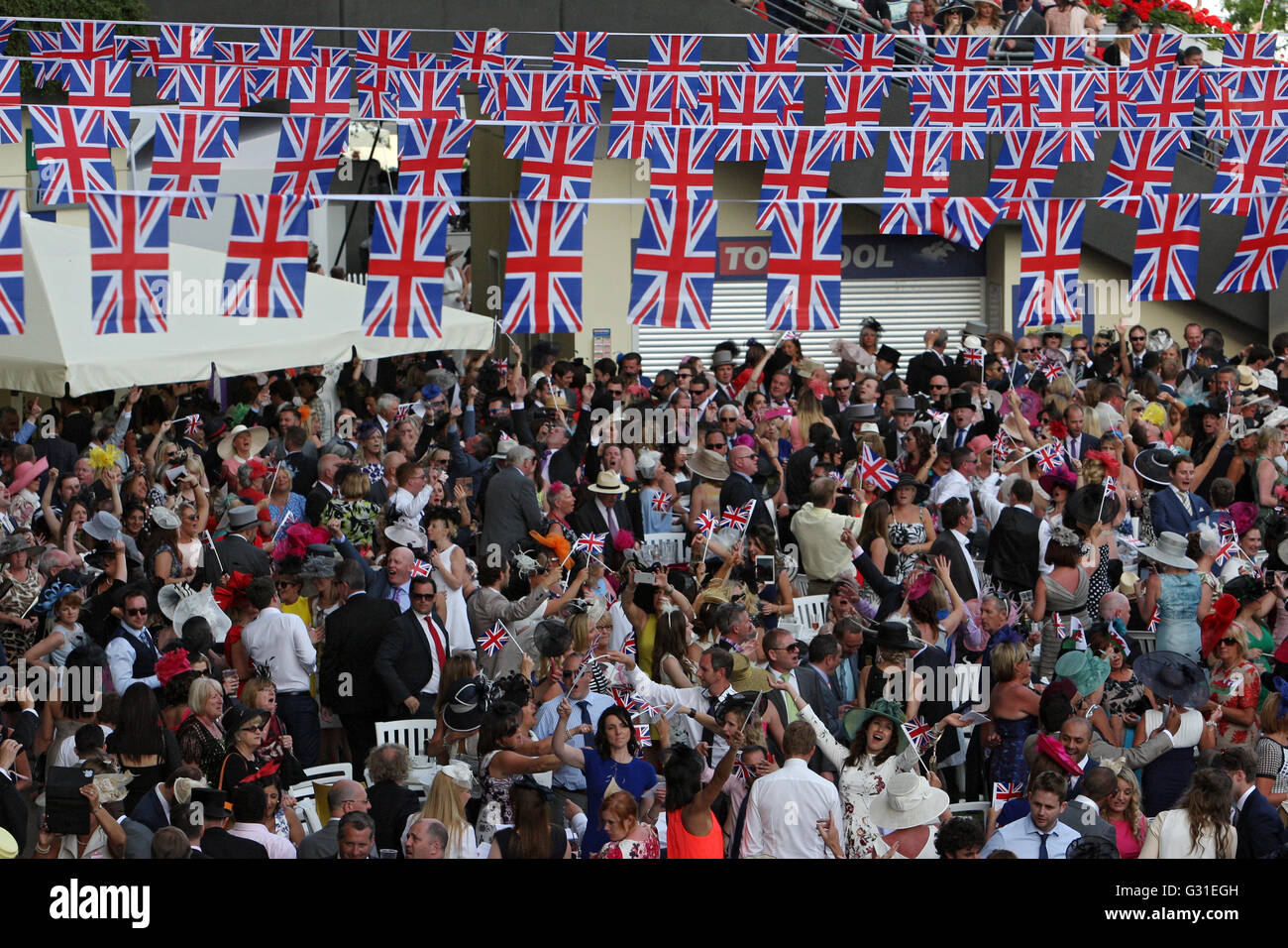 Ascot, United Kingdom, Elegantly dressed people under many national flags Stock Photo