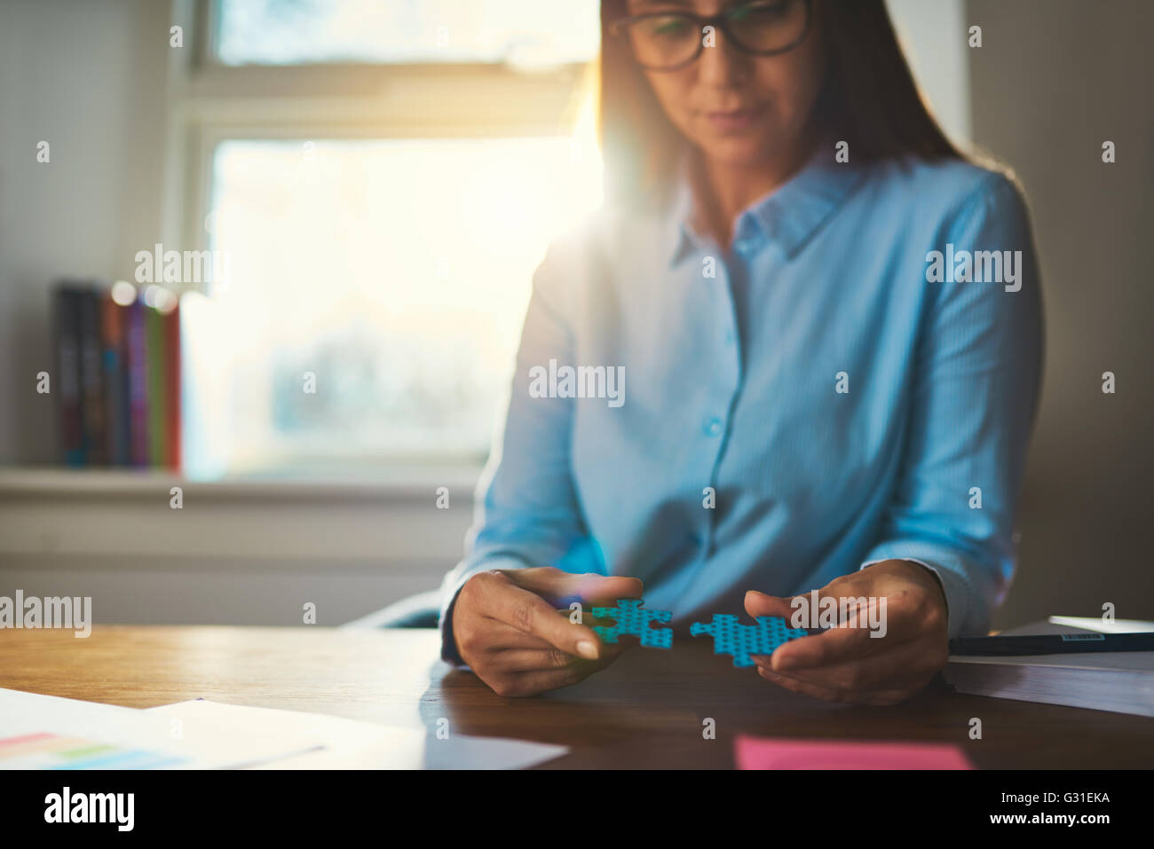 Business woman connecting puzzles, closeup of hands, success concept Stock Photo