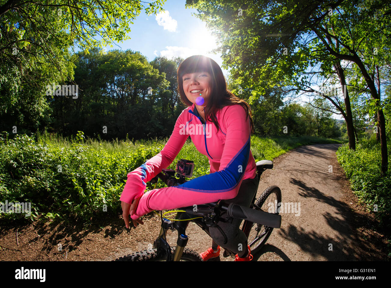 Young woman having fun riding a bicycle in the park Stock Photo - Alamy