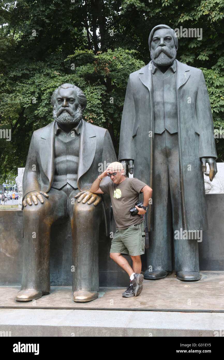 Berlin, Germany, stands in front of the bronze statues of Karl Marx and Friedrich Engels Stock Photo