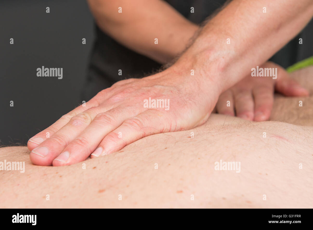 Massage therapist is working with a client Stock Photo