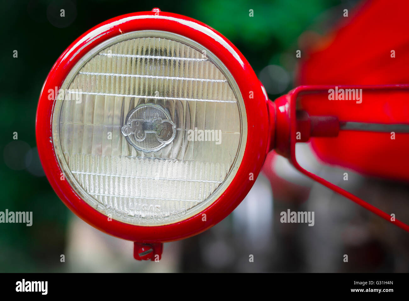 Headlamp of a vintage bright red Massey-Ferguson tractor. Stock Photo