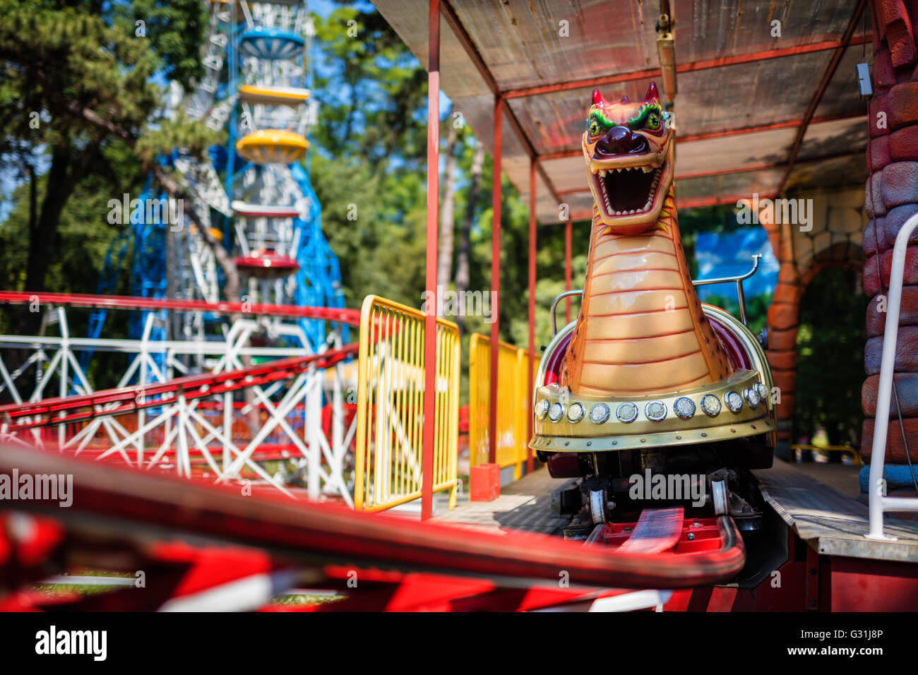 Rollercoaster on rails at Amusement park. Loop rides. Stock Photo