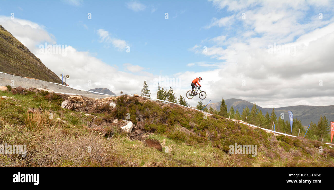 downhill mountain biker competing in the Scottish HIghlands in a Scottish Downhill Association race at Glencoe, Scotland, UK Stock Photo
