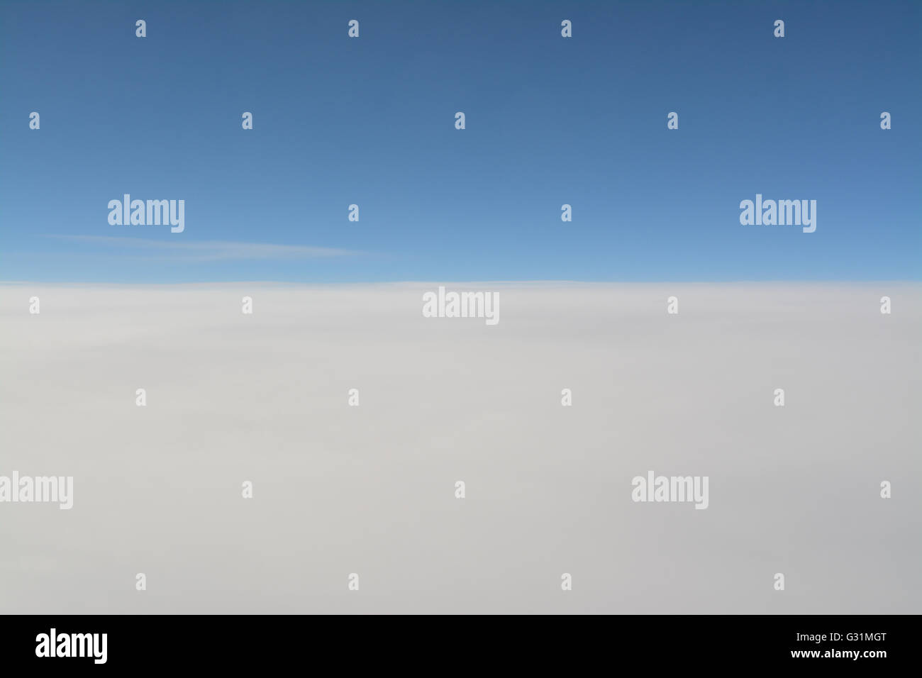 blue sky above white clouds background - view from a plane Stock Photo