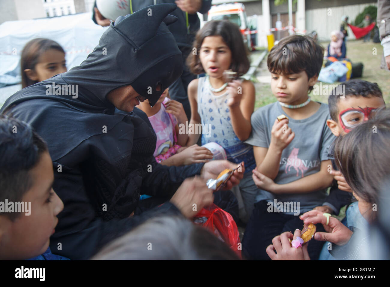 Berlin, Germany, Oemer Aslan in Batman Costume plays with children of ...